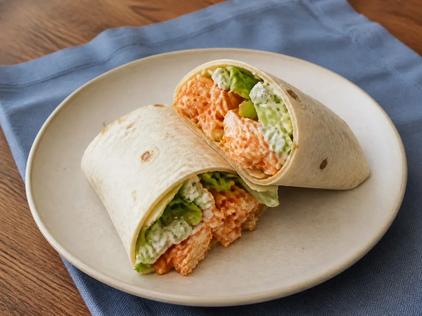 Illustrative image of buffalo chicken wraps served in a simple everyday setting