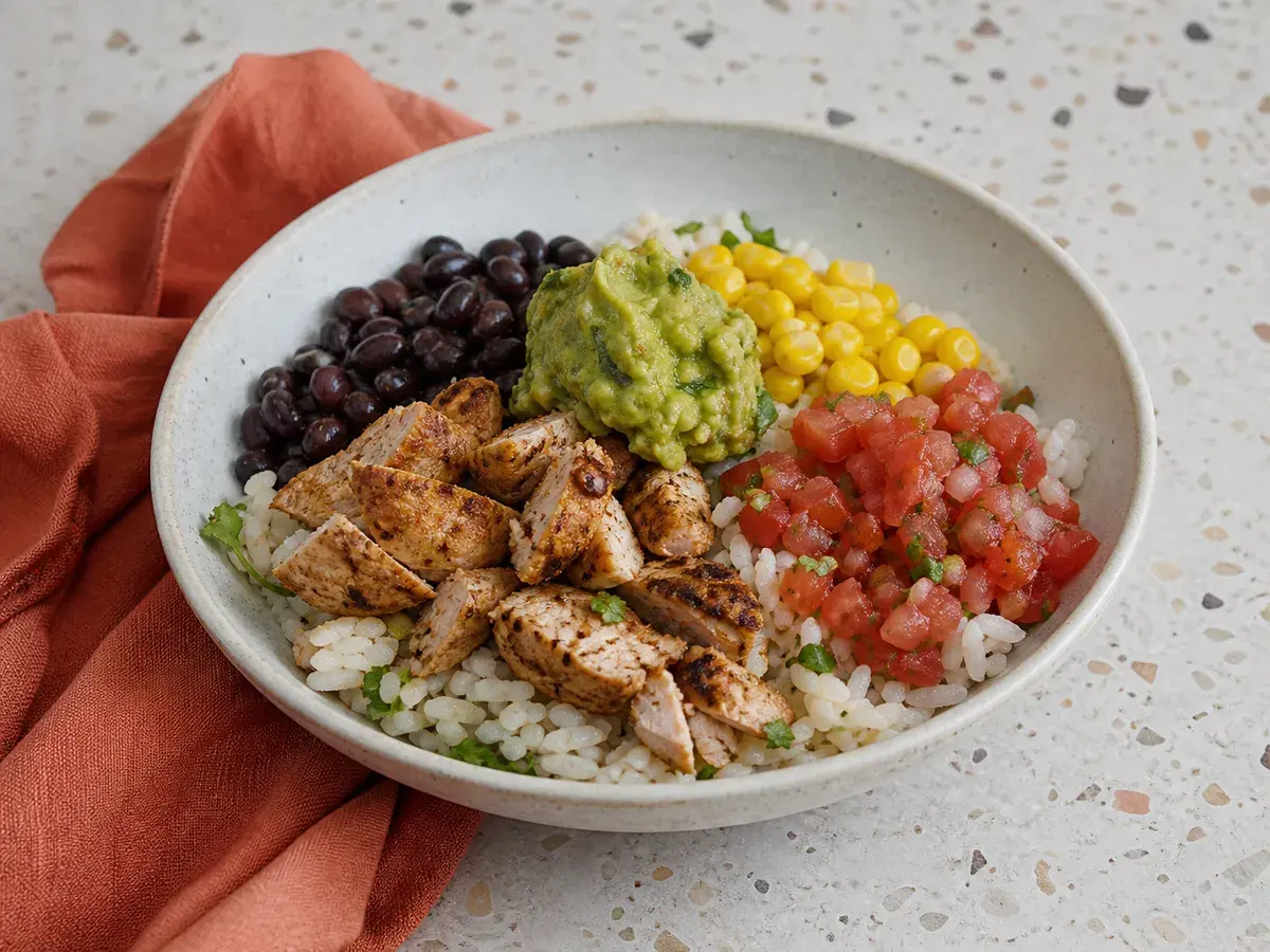 Illustrative image of chicken burrito bowl served in a simple everyday setting