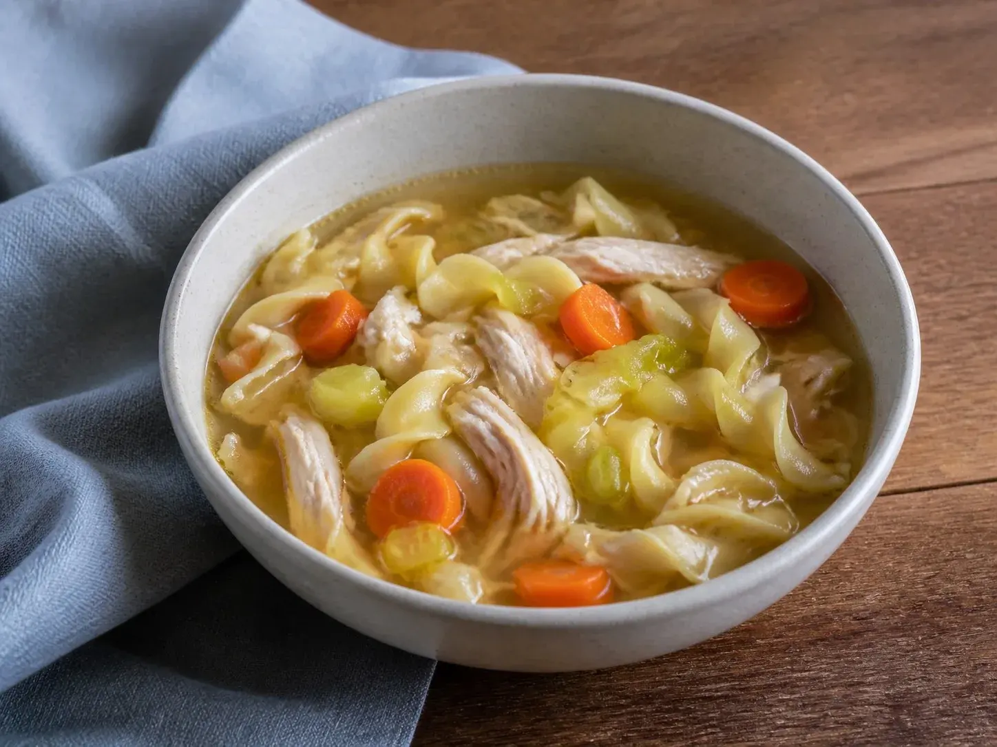 Illustrative image of chicken noodle soup served in a simple everyday setting
